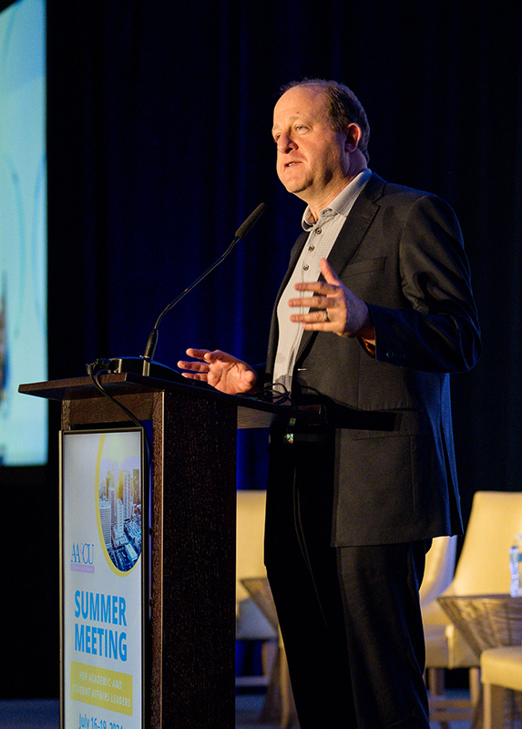 Colorado Governor Jared Polis addresses the attendees of ASM 2024. Photo Credit: Sara Hertwig for AASCU 