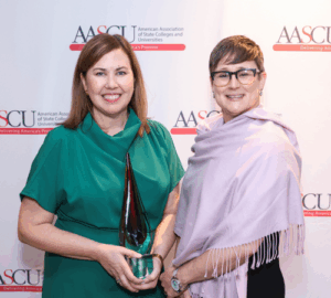 Clare Cusack receives the 2025 Distinguished Alumnus Award from President Melinda Treadwell of SUNY Geneseo