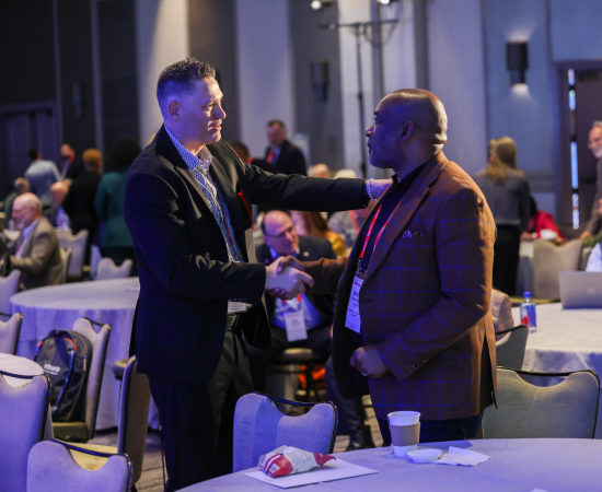 Juan Muñoz of University of California-Merced greets University of South Carolina Upstate's Bennie Harris.
